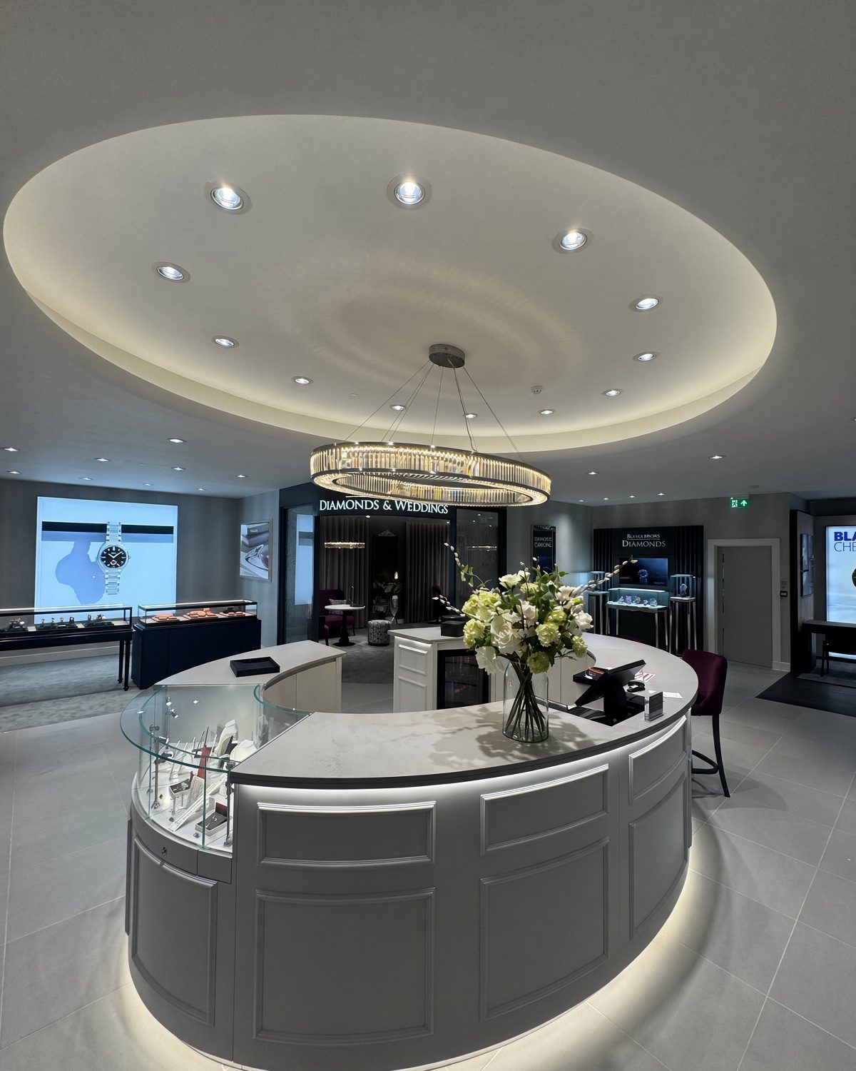 The finished bespoke oval crystal pendant hanging over the new counter at Beaverbrooks, Glasgow, with the oval ceiling recess above