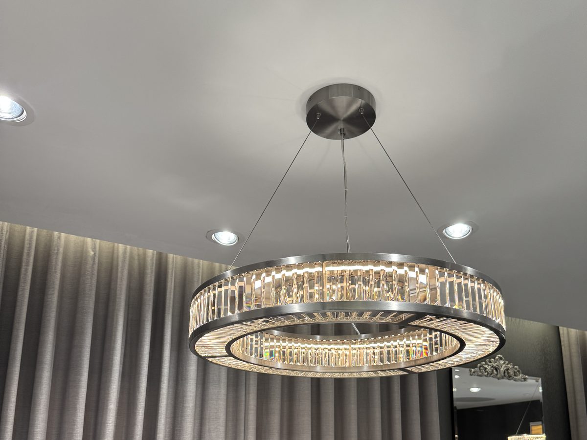 The standard round crystal ring pendant used as the reference, hanging in the store's Diamonds and Weddings room
