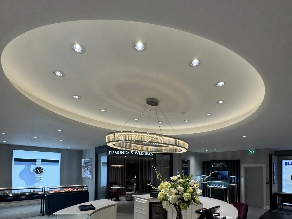 The oval pendant in place above the new curved counter, with the recessed ceiling above it