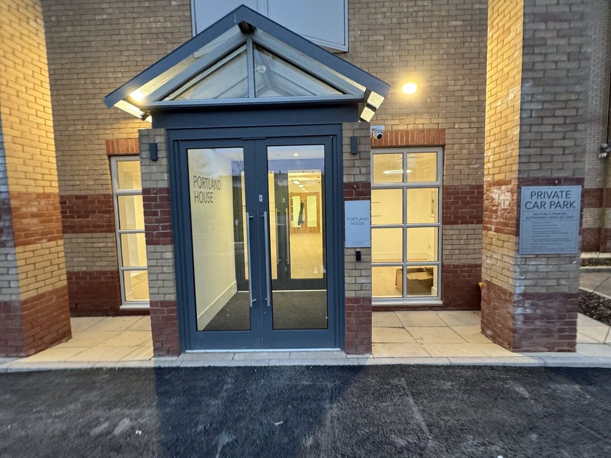 An office building entrance lit at dusk