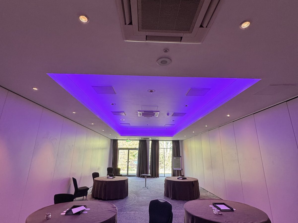A hotel conference room with colour-changing coffer lighting