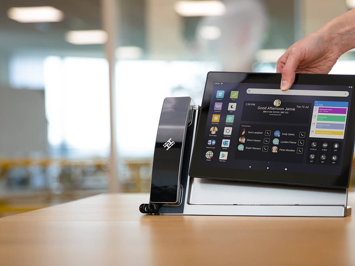 A desk handset and tablet being set up
