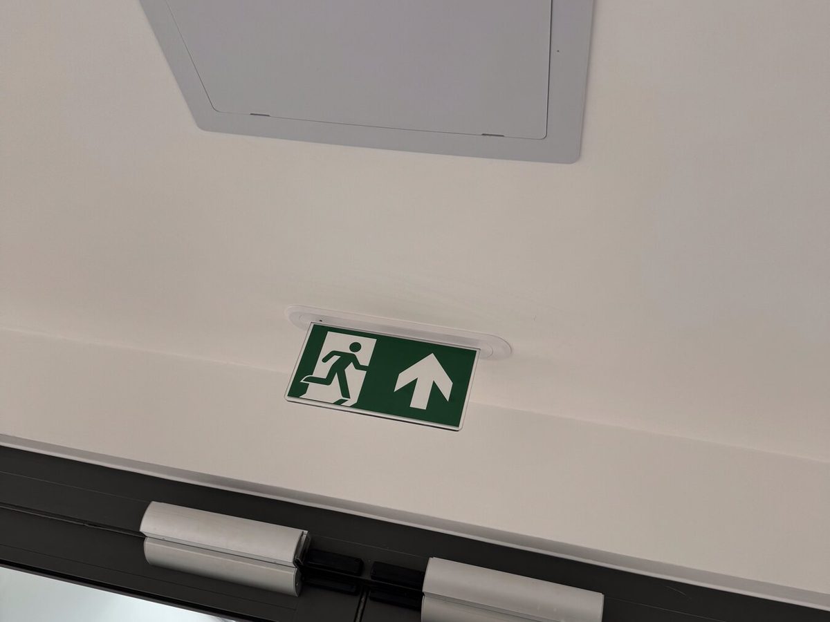 A fire exit sign above a set of doors
