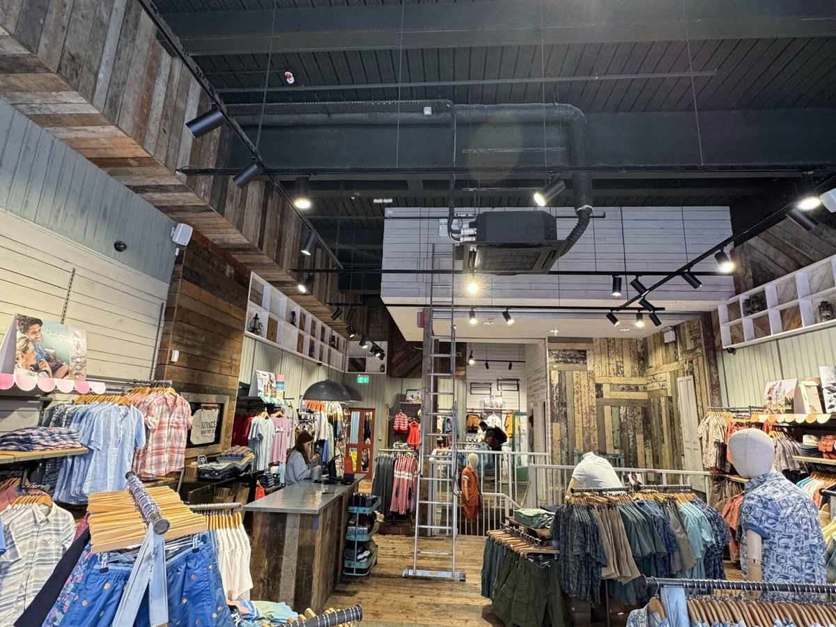 A FatFace store with timber-clad walls and spotlights