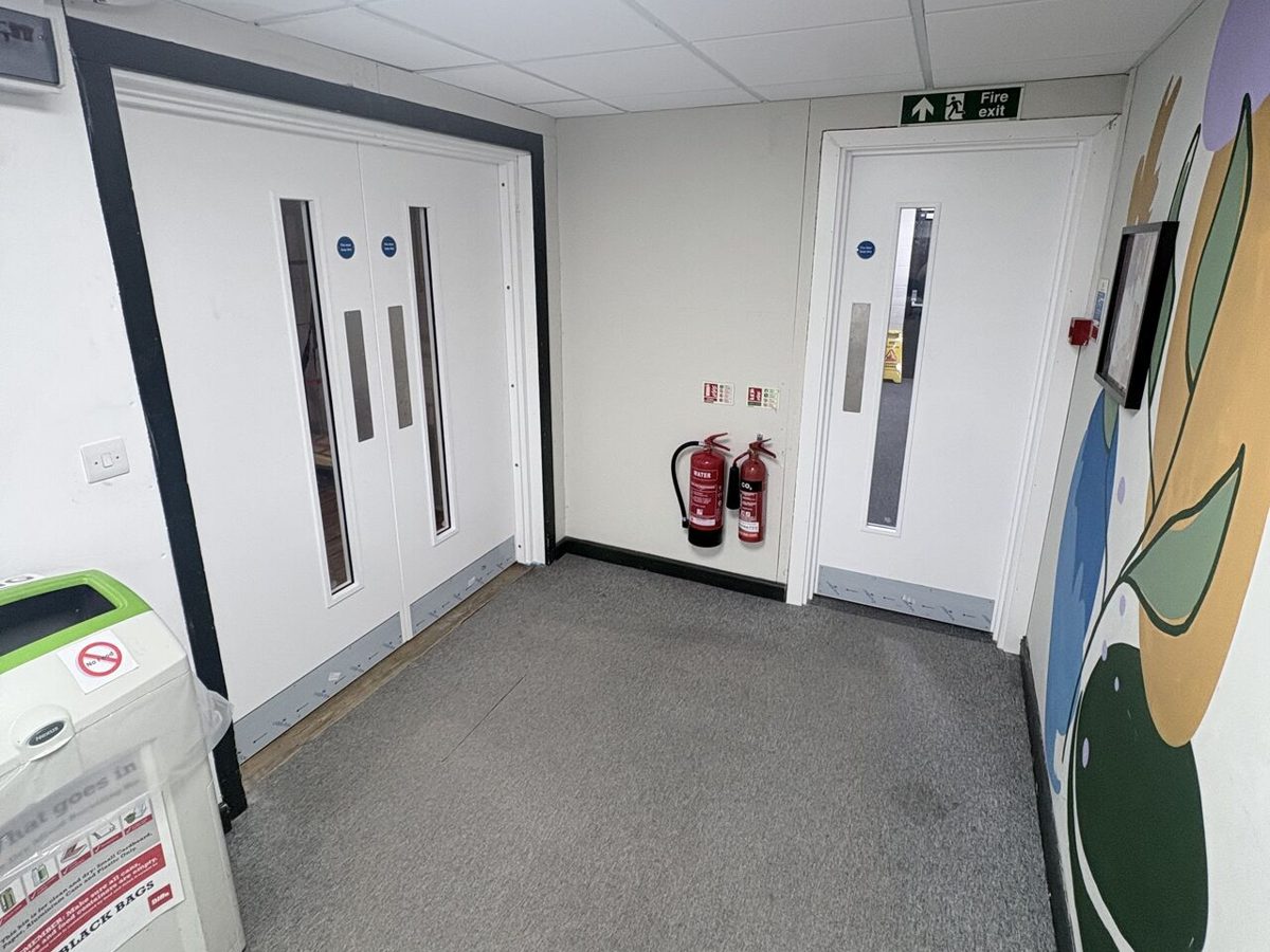 New double fire doorset and single fire exit door in a lobby with extinguishers and fire exit signage
