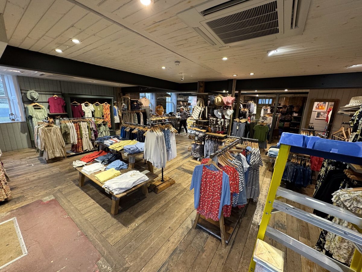 Rails of clothing on a FatFace shop floor