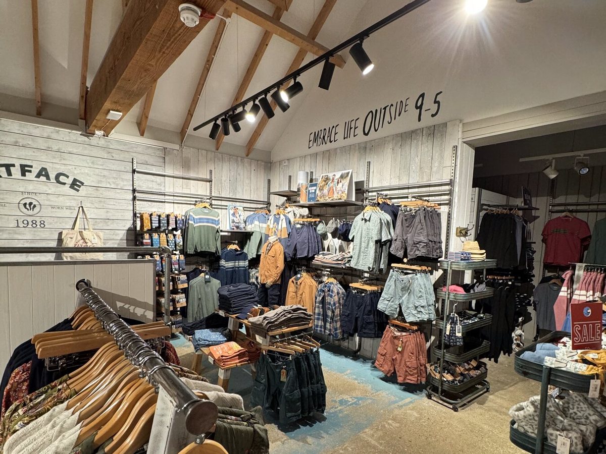 Spotlights mounted on the timber beams of a FatFace store