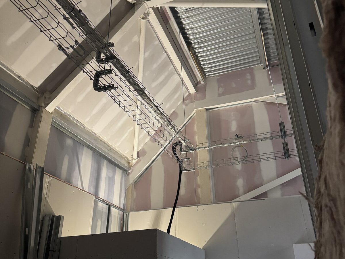 Two engineers reviewing progress during a store fit-out