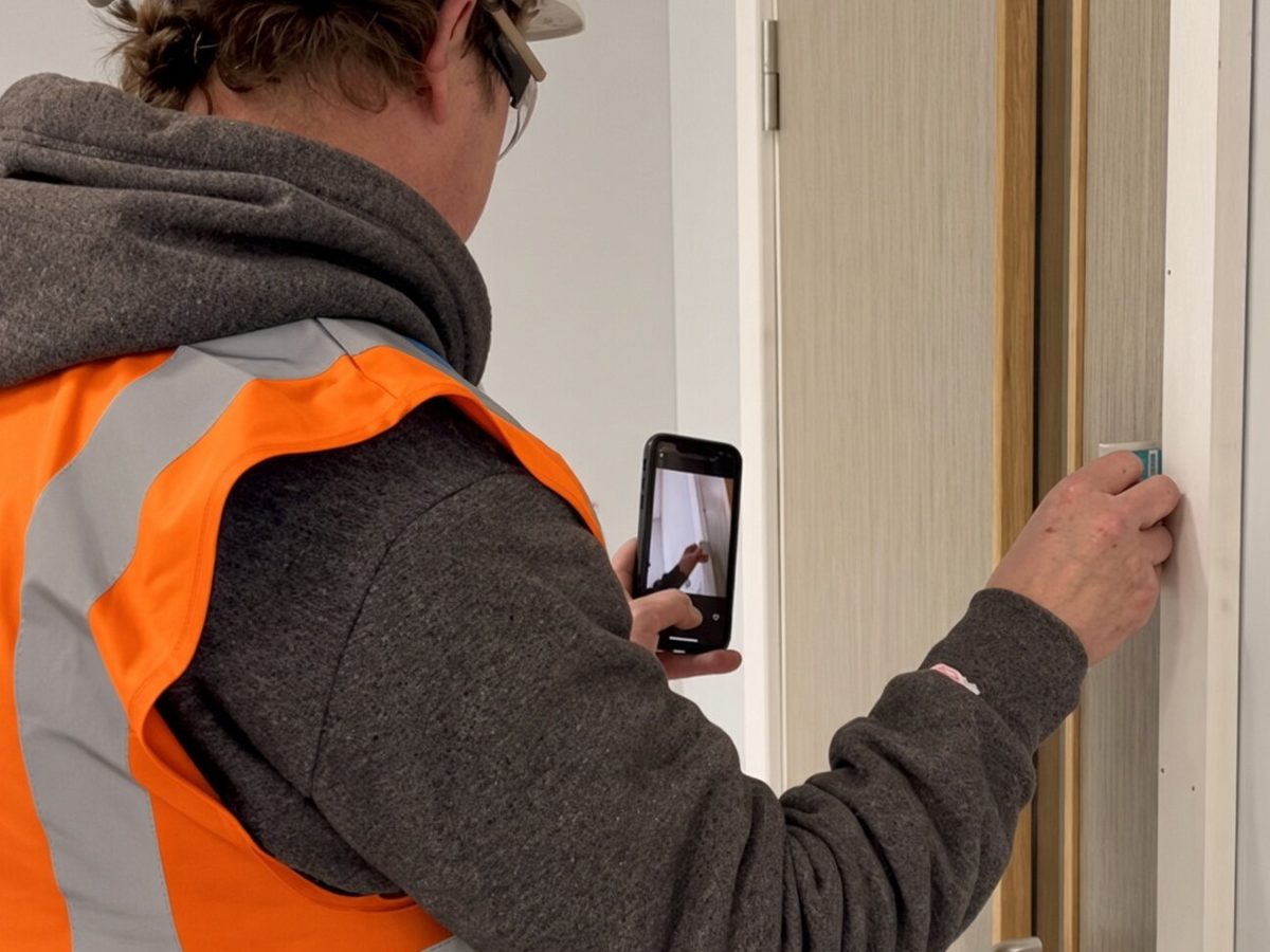 An engineer adjusting a door and frame