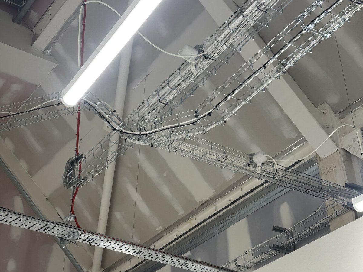 New LED battens installed on the roof steelwork of a retail unit