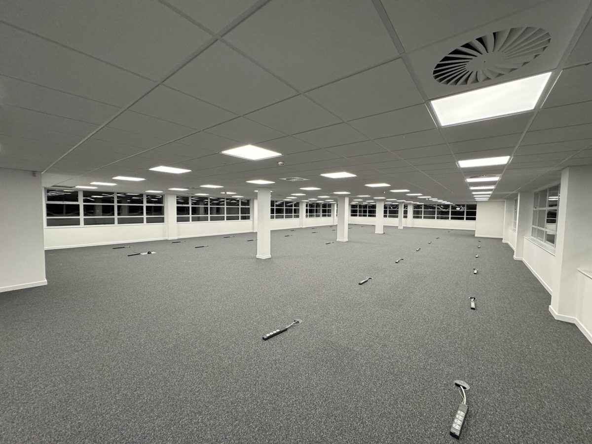 An open-plan office floor after electrical and lighting works