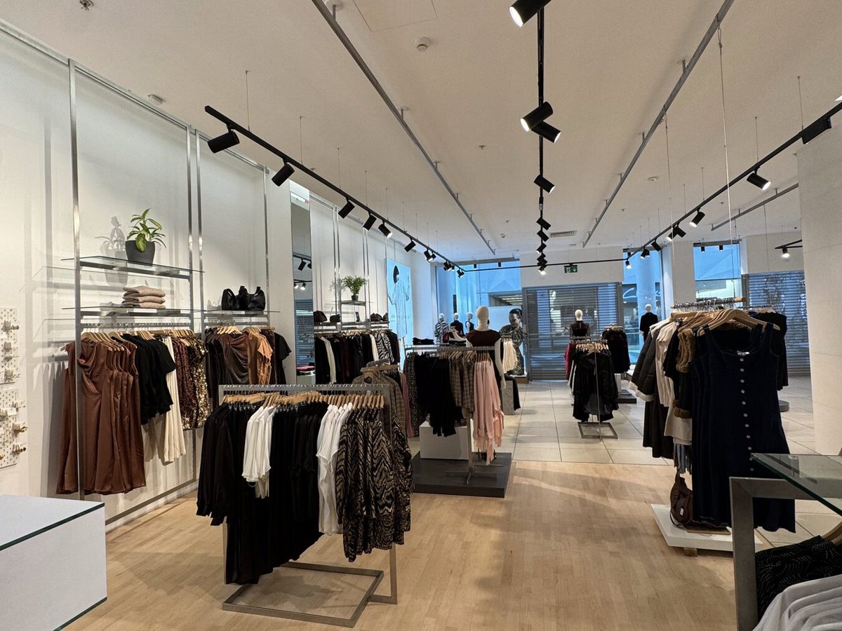 A fashion store shop floor under track lighting
