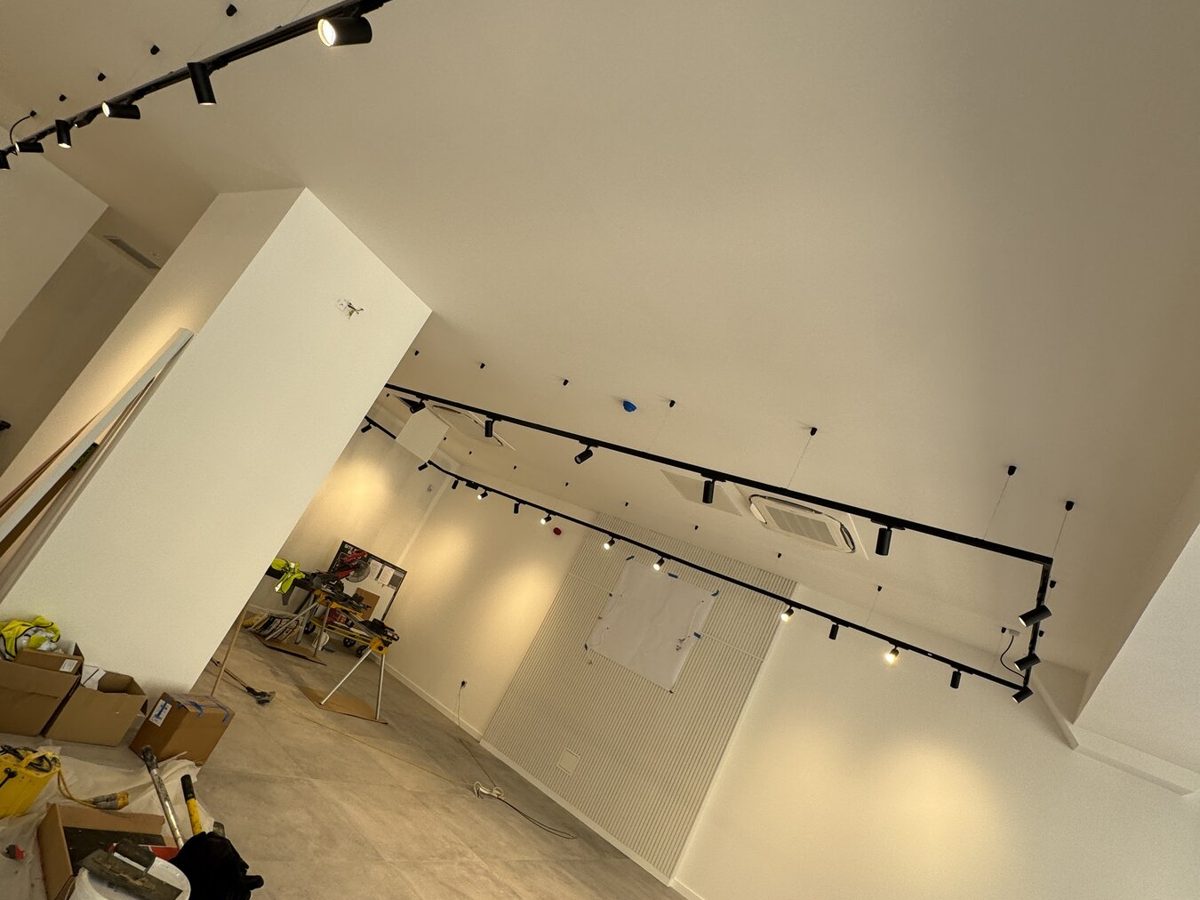 Black lighting track installed in a retail unit during fit-out
