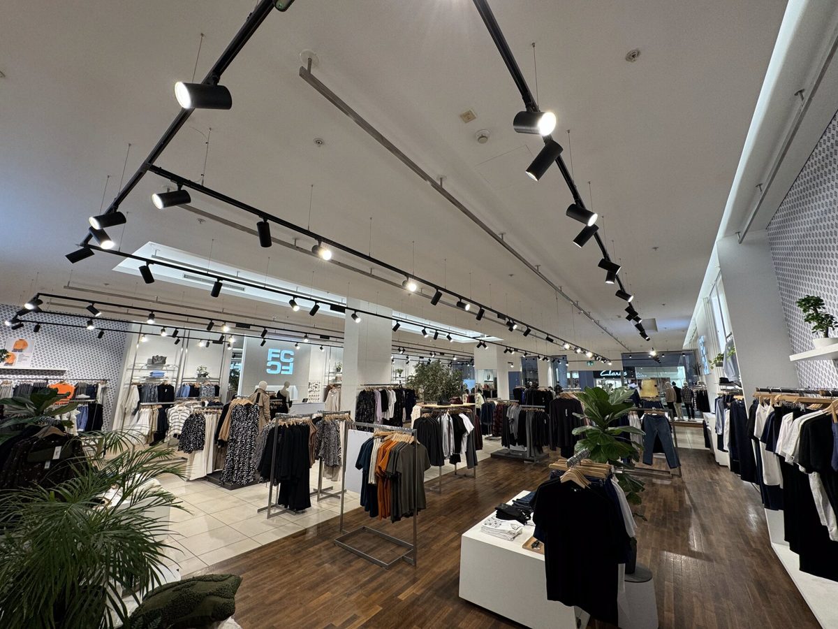 Track spotlights and cove lighting across a fashion store