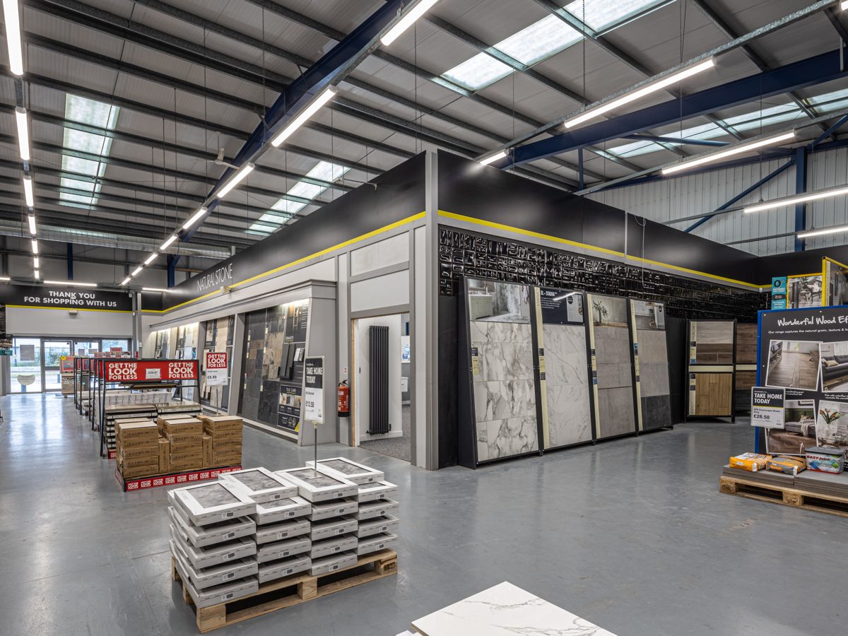 LED battens on the trunking against the roof steelwork, with an emergency luminaire alongside