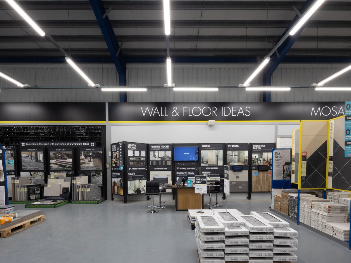 A wide view across the store towards the entrance, with rows of LED battens above the display walls
